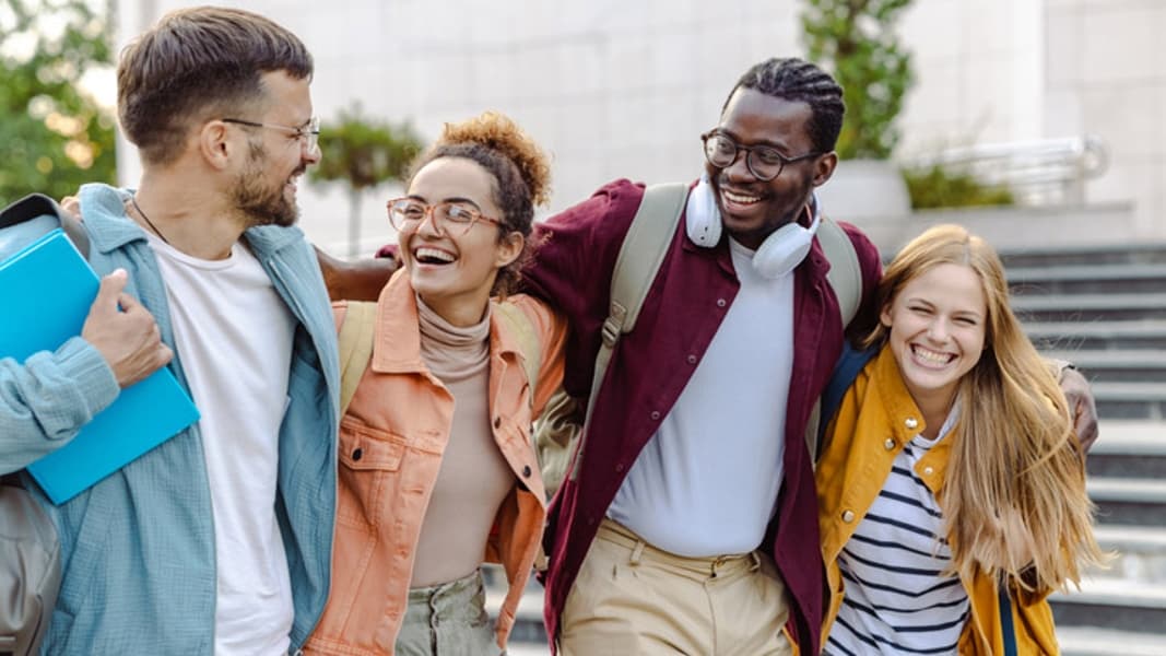 Happy group of students on the street - stock photo